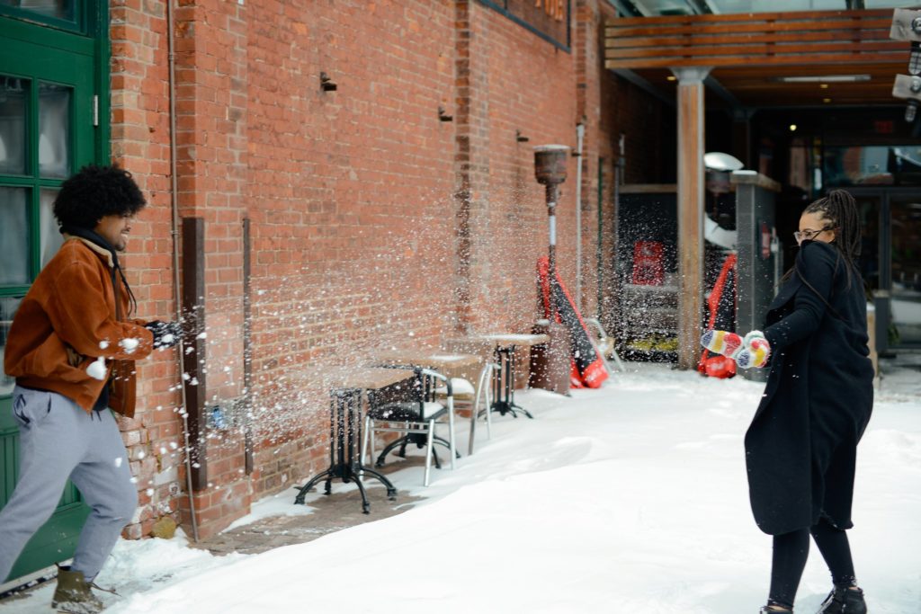 couple playing in show at engagement photoshoot in toronto