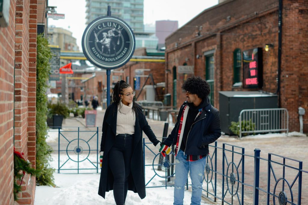couple holding hands in distillery district in toronto