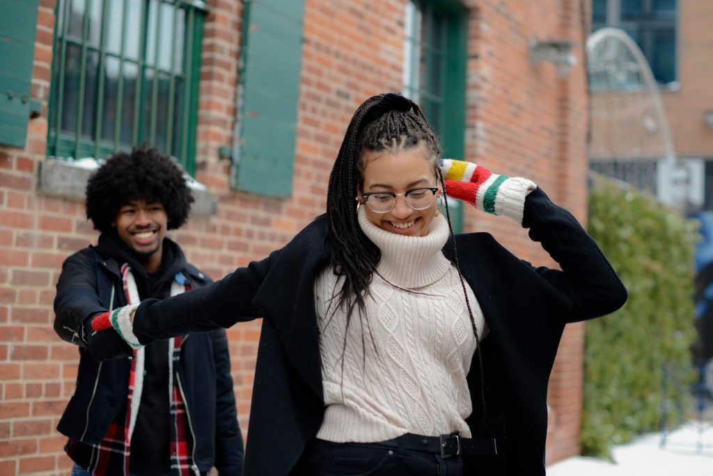 toronto couples photoshoot with smiling woman pulling hand of man behind her