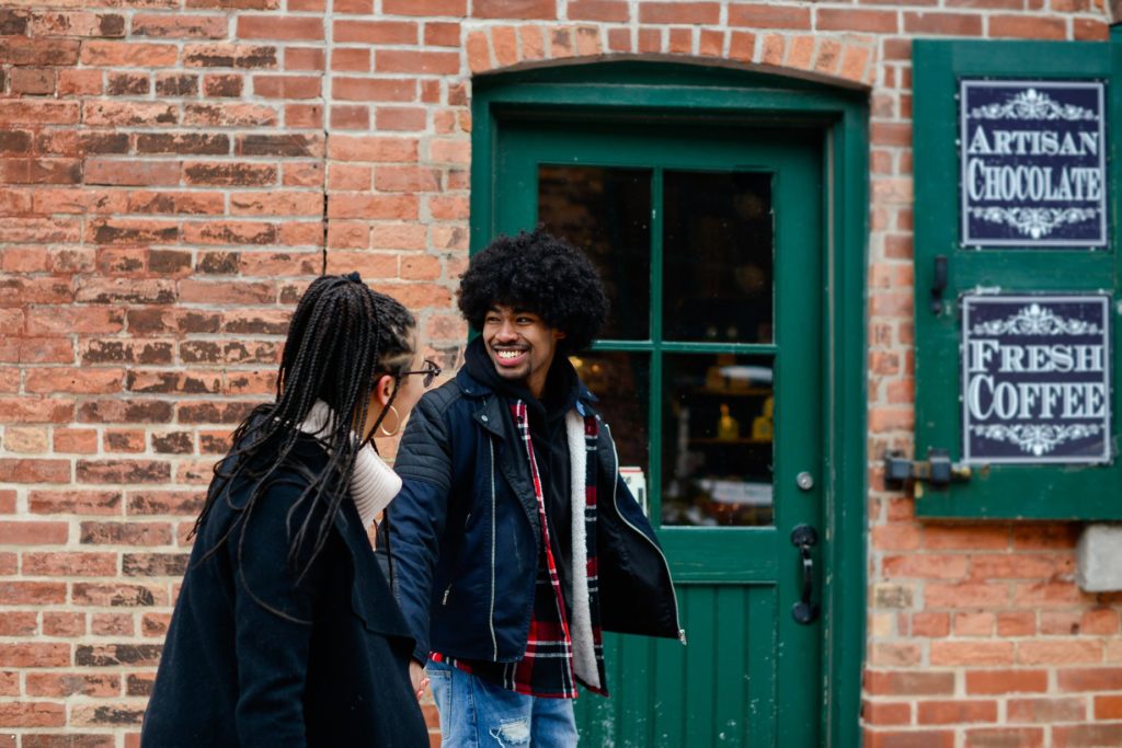 smiling couple walking in toronto for engagement photography session