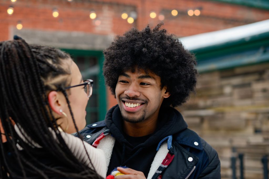 smiling man looking at woman 