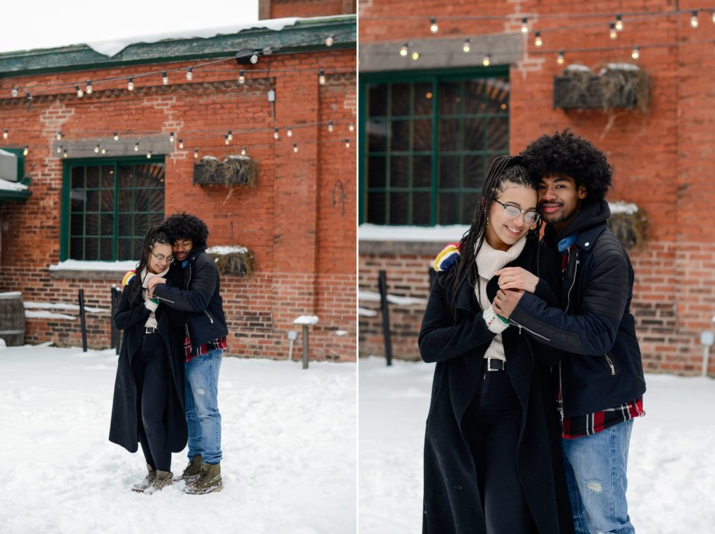 two photos of couple posing in the snow against red brick wall for engagement photoshoot