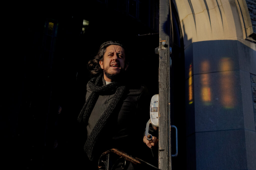 Kris Siddiqi opens the door from the church to heavy cold winds in a scene from T.A.R.T