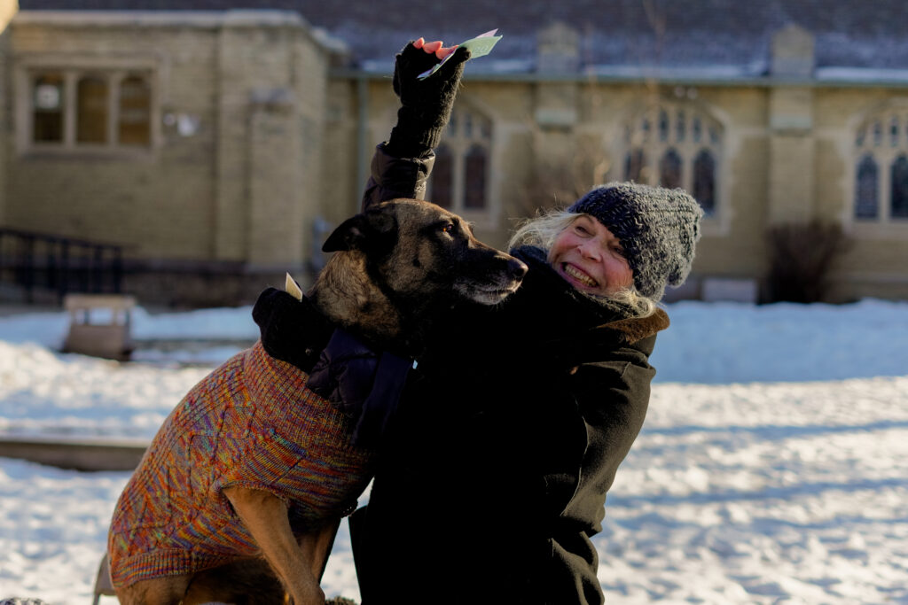 Trudy Weiss celebrates with her dog after she makes a sale in a scene from T.A.R.T