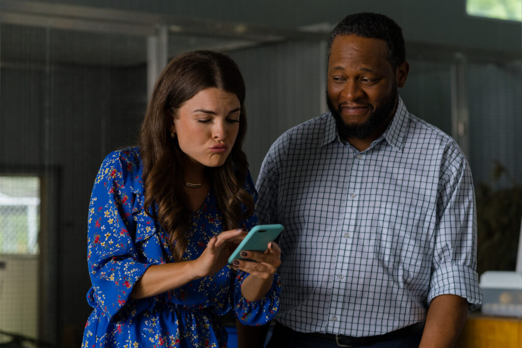 Madeline Leon shows photo to Bobby Daniels at the vets she works at in Love in Wolf Creek, a Hallmark movie