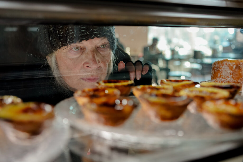 Trudy Weiss looks into the glass cabinet and choses a Tart in a scene from T.A.R.T
