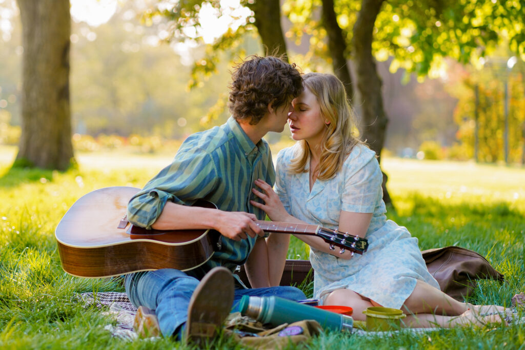 London UK Stills Photographer - Adelaide Clemens sits having a picnic with Douglas Smith in a park in a scene from The Swearing Jar