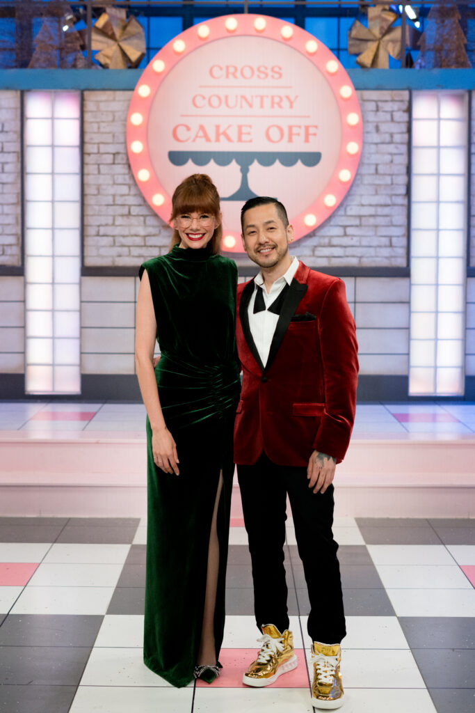 Mary Berg and Chef Andrew Han stands infront of Cross Country Cake Off sign