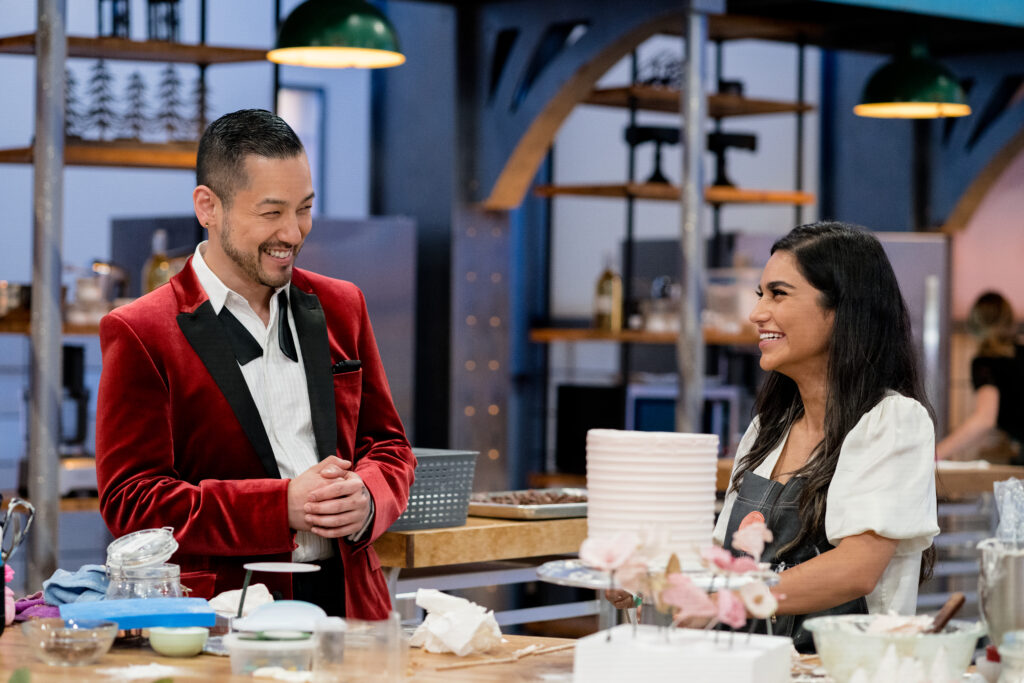 Chef Andrew Han speaks to one of Cross Country Cake Off's contestants