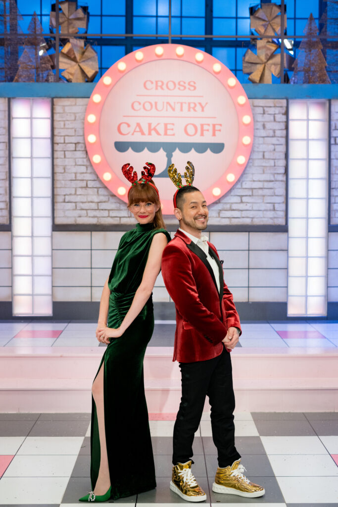 Mary Berg and Chef Andrew Han stands infront of Cross Country Cake Off sign