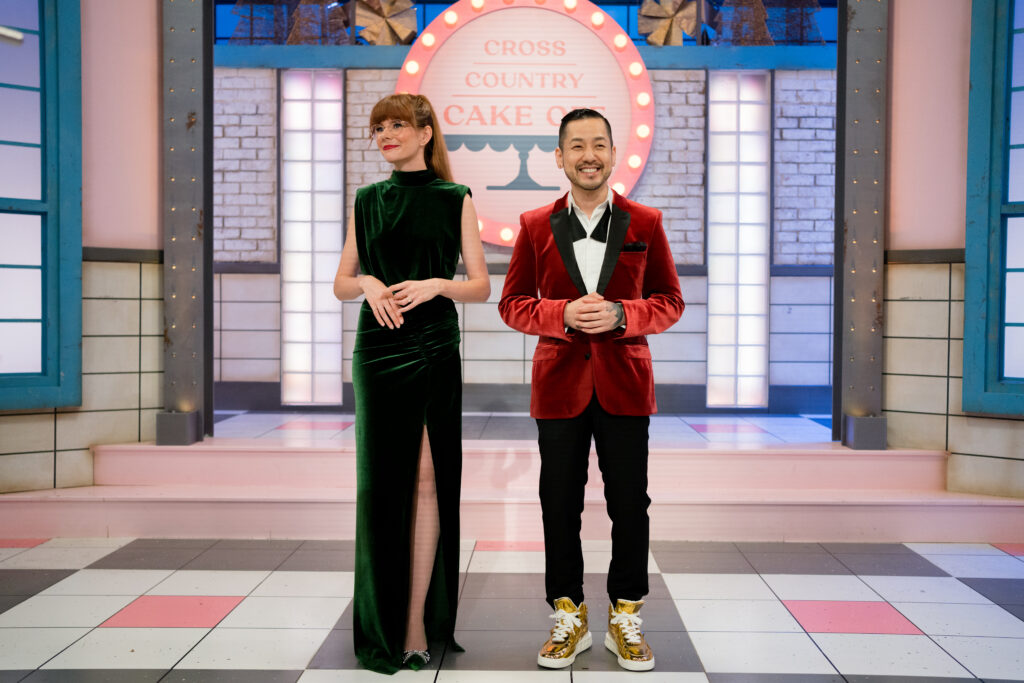 Mary Berg and Chef Andrew Han stands infront of Cross Country Cake Off sign