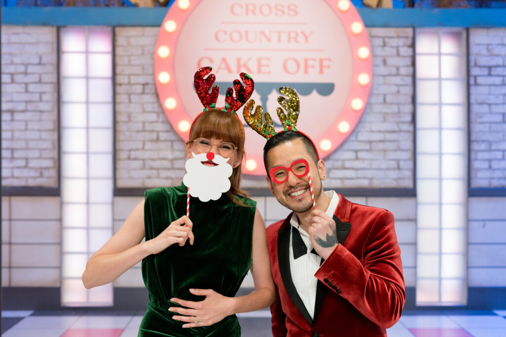 Mary Berg and Chef Andrew Han stands infront of Cross Country Cake Off sign