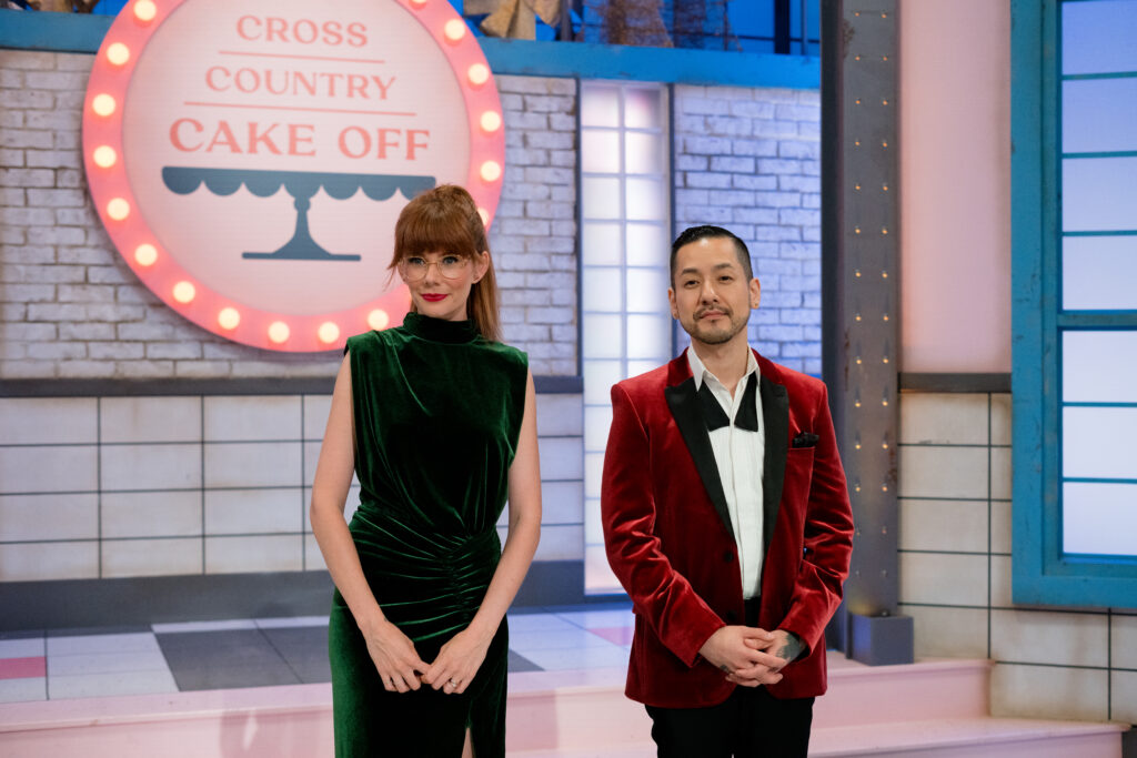 Mary Berg and Chef Andrew Han stands infront of Cross Country Cake Off sign