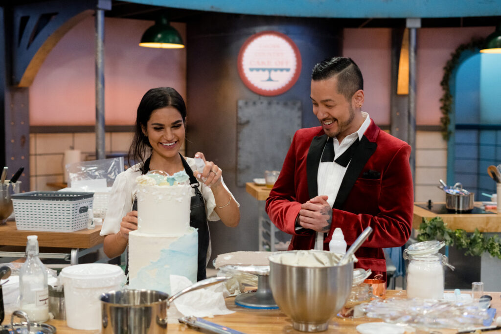 Chef Andrew Han speaks to one of Cross Country Cake Off's contestants