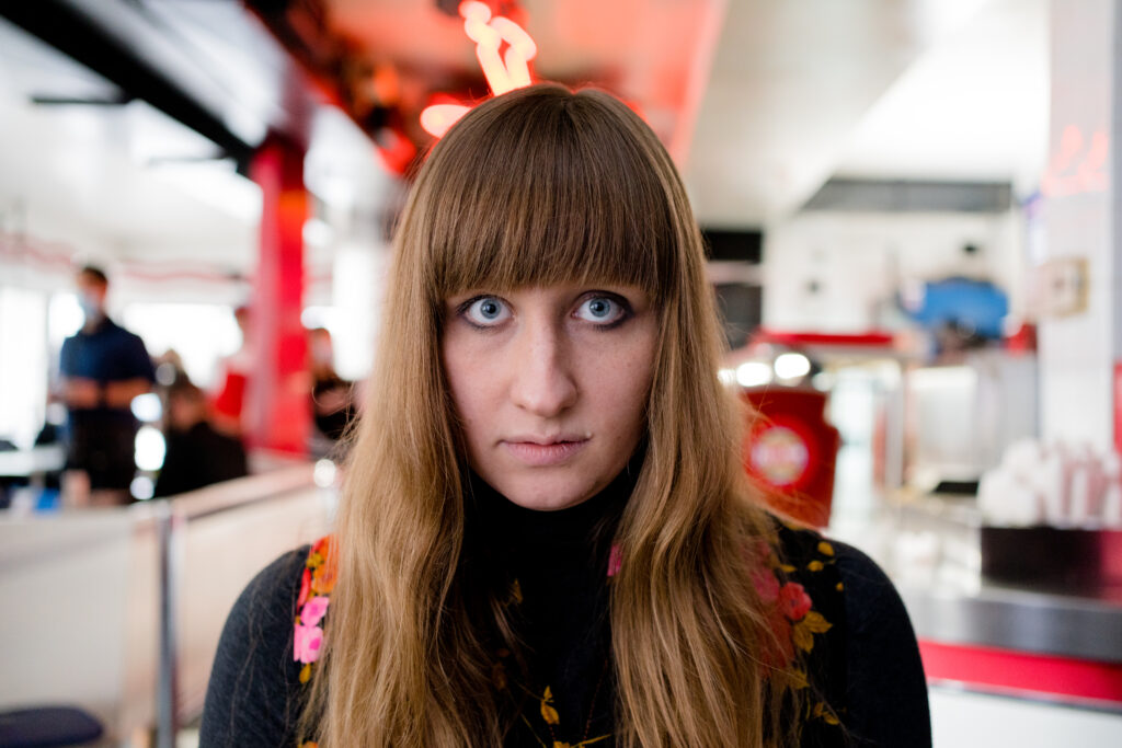 Lily Kazimiera looks straight to camera in a posed Stills photo for I hate people, people hate me