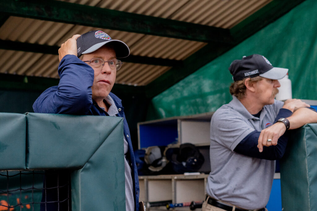 Greg Kinnear looks concerned as he coachs softball game in movie You Gotta Believe