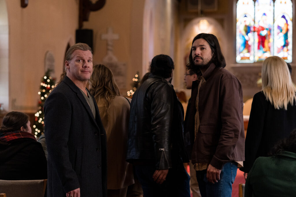 Chris Jericho and Craig Stickland look over their shoulder in church in scene from Country Hearts Christmas