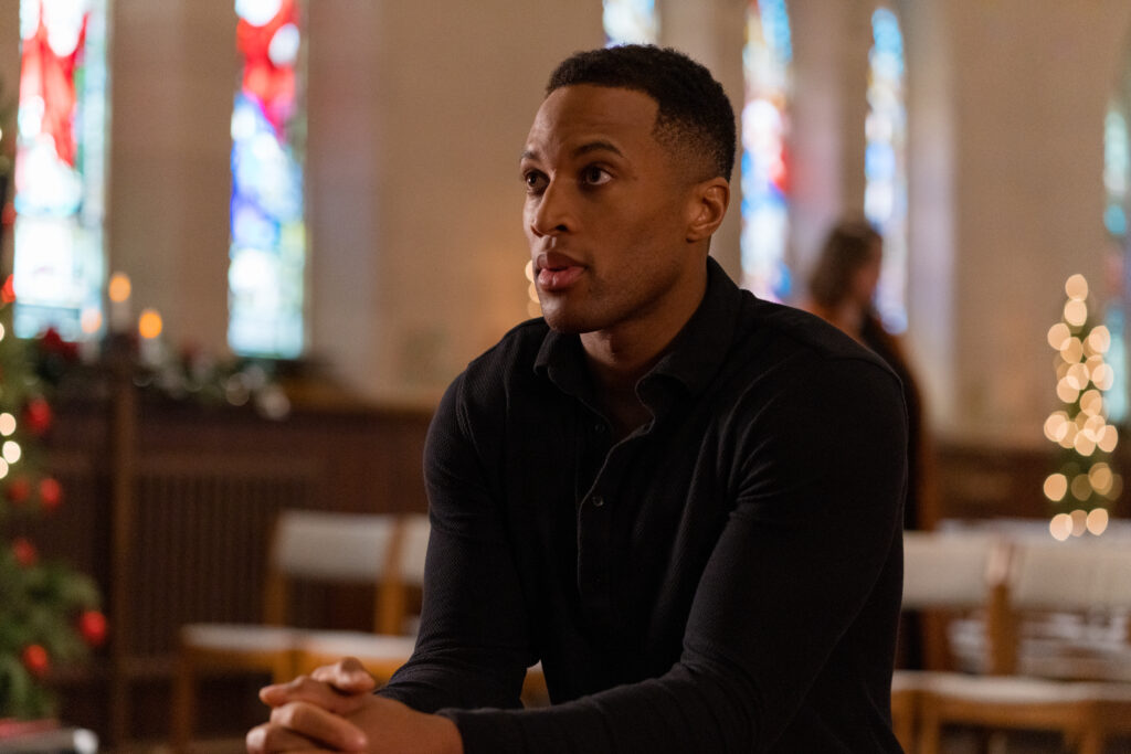 Brendan Morgan sits in church Lanie Mcauley and Katerina Maria sing on stage in scene from Country Hearts Christmas