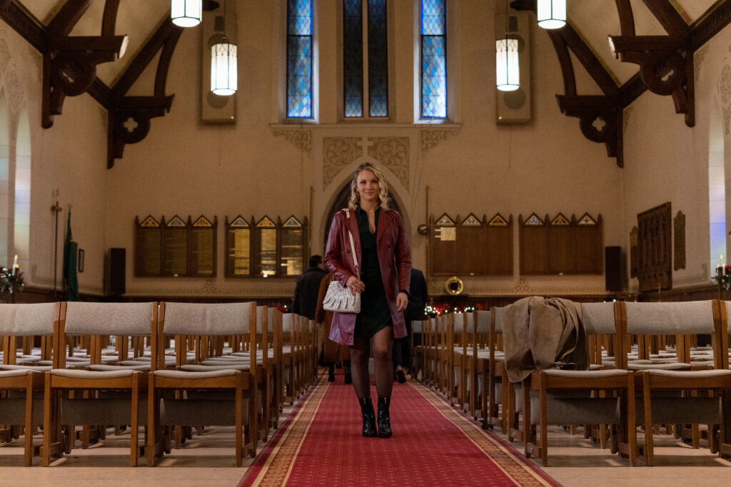 Lanie Mcauley walks down hall in church Lanie Mcauley and Katerina Maria sing on stage in scene from Country Hearts Christmas