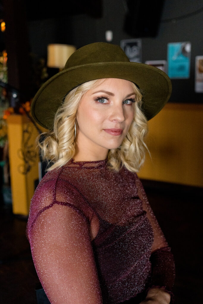 Lanie Mcauley looks to camera posing on set of Country Hearts Hallmark film