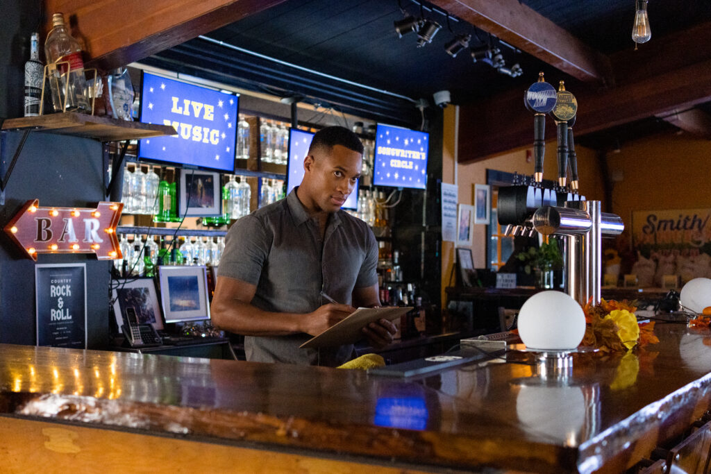 Brendan Morgan stars at Lanie Mcauley from behind the bar