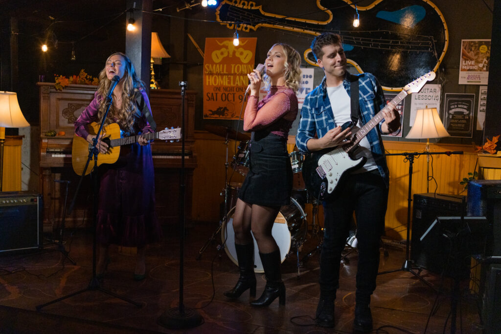 Lanie Mcauley, Katerina Maria and David Pinard perform onstage in Hallmark movie Country Hearts