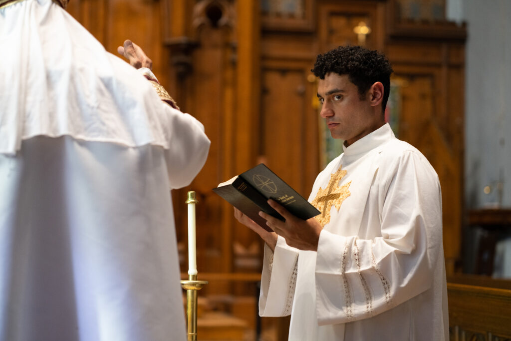 Ryan Ali's love interest stands helping in the church in a scene from the movie Queen Tut