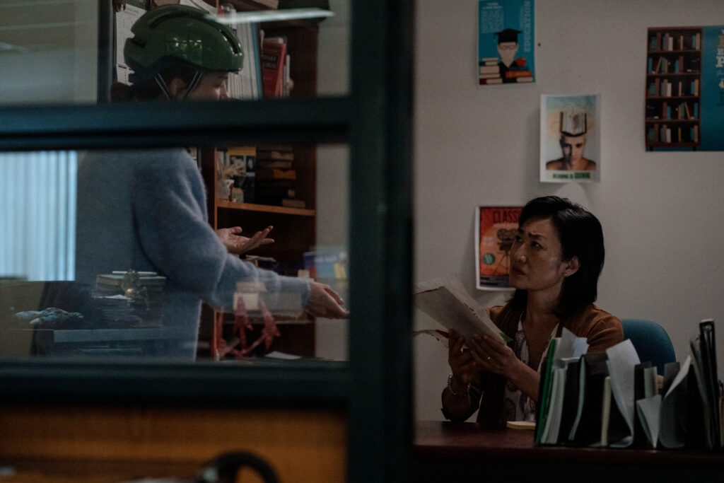 Britt Lower as Miriam speaks with her boss Jean Yoon in library in Darkest Miriam