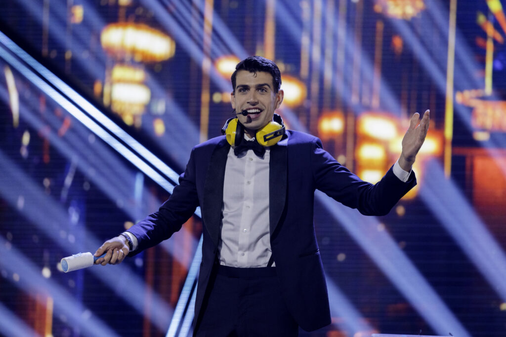 Magician Mark Clearview on Canadas Got Talent with arms open listens to the applause he receives