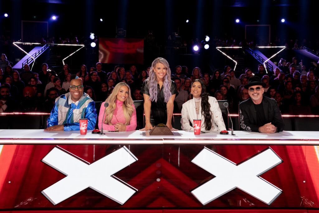 London UK Stills Photographer - Judges of Canadas Got Talent sit and pose at judges desk with Howie Mandel, Lindsay Ell, Trish Stratus, Lilly Singh, Kardinal Offishall