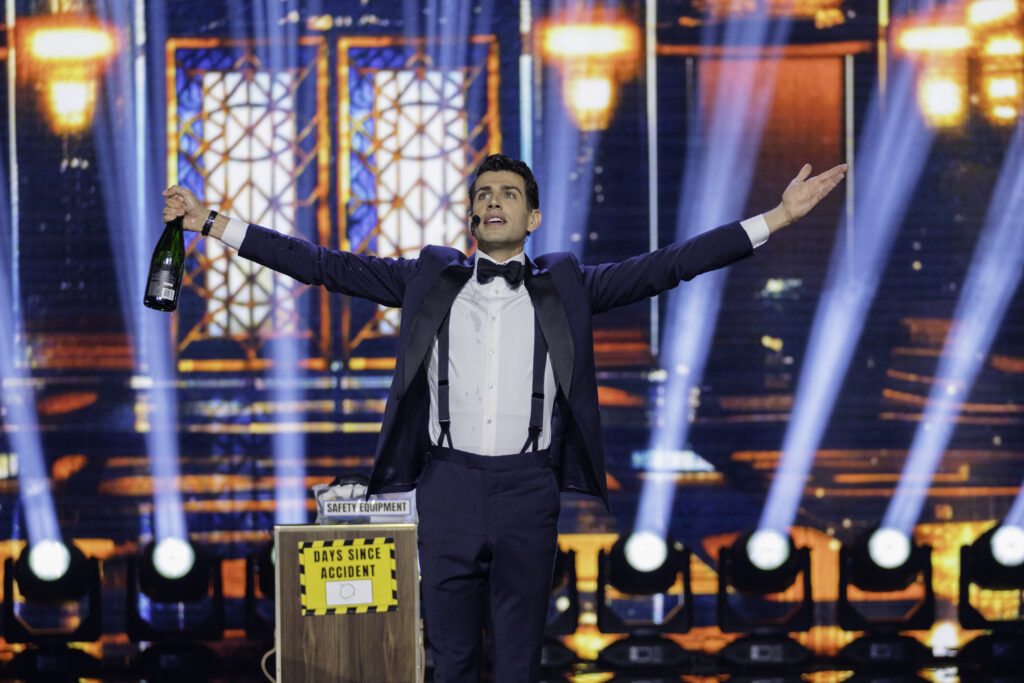 Magician Mark Clearview on Canadas Got Talent with arms open listens to the applause he receives