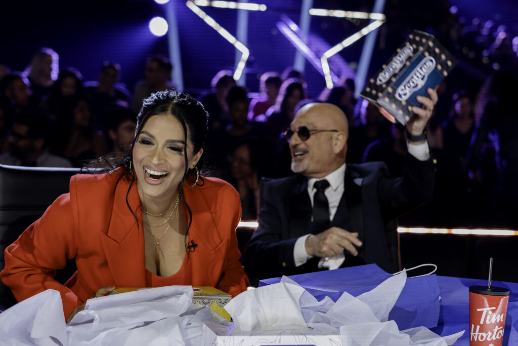 Candid photo of Howie Mandel and Lilly Singh laughing together while on Canadas Got Talent