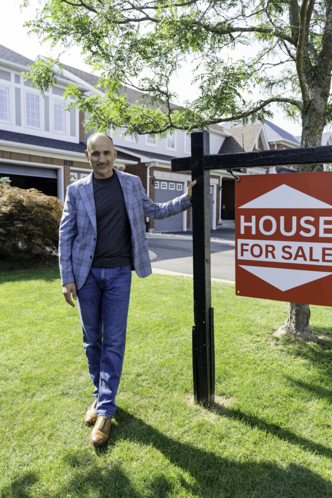 David Turner in suit poses for photo in renovated Love it or List it house