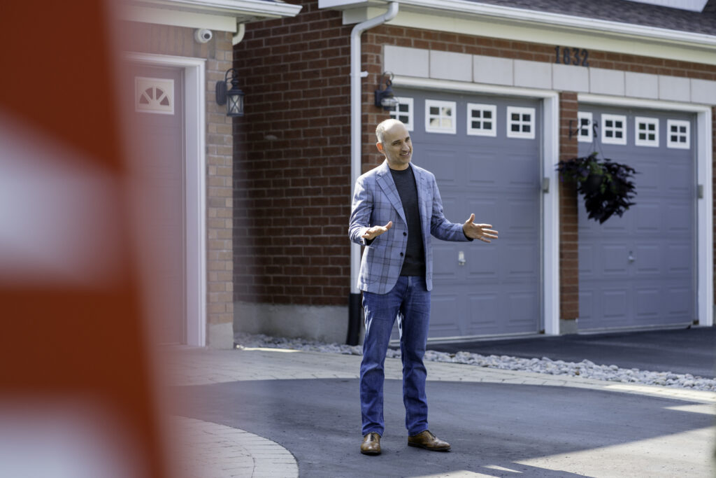 David Turner in suit poses for photo in renovated Love it or List it house