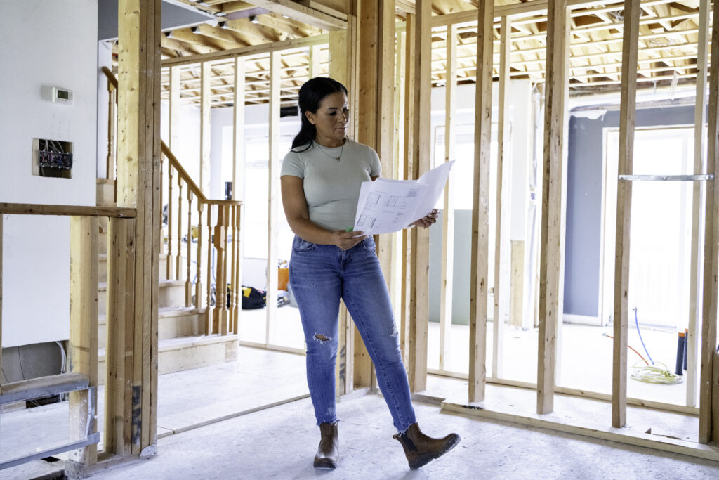 Page Turner poses for photo in Love it or List it house under renovation