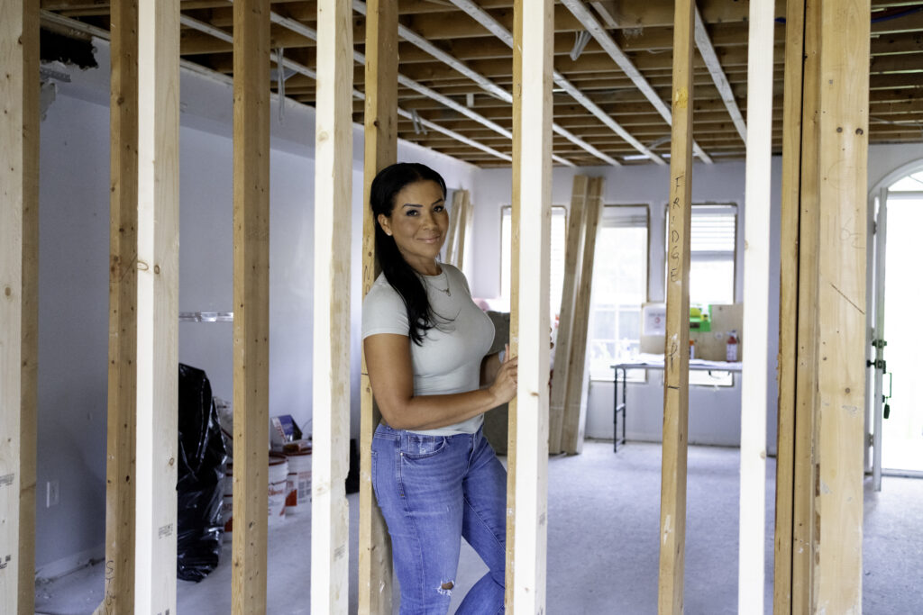 Page Turner poses for photo in Love it or List it house under renovation